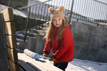 Poster - Cute little girl playing with snowball maker outdoors