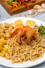 Wall Mural - Mie rebus medan or Noodle Soup 

The dish is made of yellow egg noodles, which are also used in Hokkien mee, with a spicy slightly sweet curry-like gravy. The gravy is made from shrimp or tauchu broth