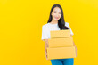© siraphol - Portrait beautiful young asian woman with box ready for shipping