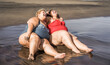 © DisobeyArt - Plus size women sitting on the beach having fun during summer vacation - Focus on faces