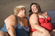© DisobeyArt - Plus size women sitting on the beach having fun during summer vacation - Focus on faces