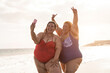 © DisobeyArt - Curvy women friends taking selfie on the beach during summer vacation - Soft focus on left woman face