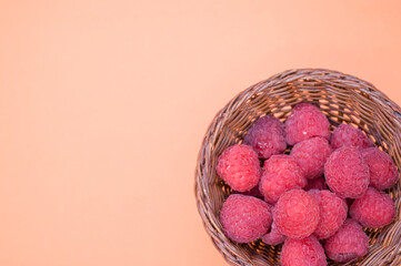 Sticker - Small basket with fresh raspberries isolated on a light-colored background