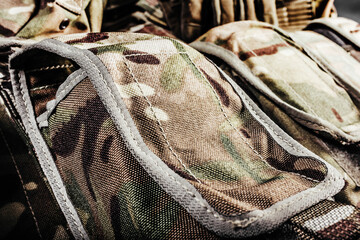 Wall Mural - Close-up photo of multi camouflaged soldier vest pouches.