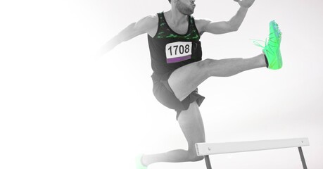 Canvas Print - Composition of male athlete hurdle jumping with copy space on white background