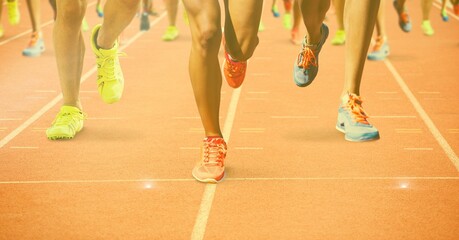 Wall Mural - Composition of legs of athletes running on racing track