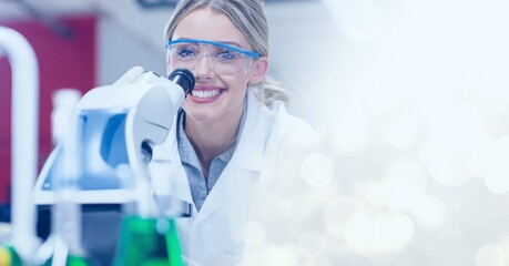 Poster - Composition of smiling female lab technicians using microscope, with white bokeh copy space to right