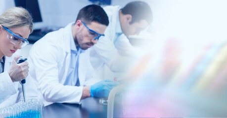 Wall Mural - Composition of male and female lab technicians at work, with blurred copy space to right