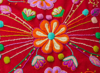 Peruvian crafts: Embroidered flower ornaments on a handmade fabric