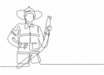 Wall Mural - Continuous one line drawing of young male firefighter holding water nozzle. Professional job profession minimalist concept. Single line draw design vector graphic illustration