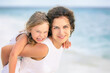 © sborisov - Portrait of happy mother and little daughter on ocean beach on Maldives at summer vacation. Family on the beach concept.