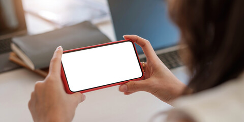 Wall Mural - Close-up Of A Woman's Hand Holding Cell Phone With White Blank Screen