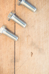 Poster - Top view of long silver bolts on a wooden surface