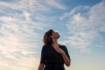 portrait of woman looking up to the sky