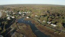 Aerial Panning Tidal Wetlands And Homes On The Northern New England Coast With Clear Blue Skies And The Warm Sunlight Of Dawn - Kennebunkport, Maine
