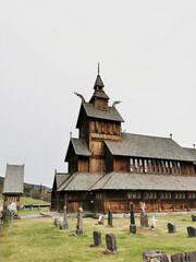 Poster - Beautiful wooden church, also known as a Stave church, and a cemetery in Norway