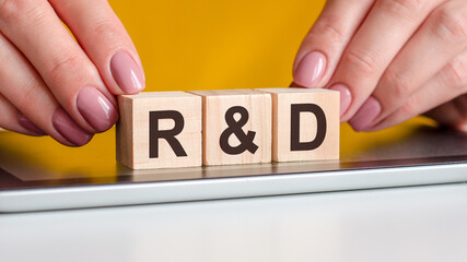 the word r and d is written on wooden cubes, concept