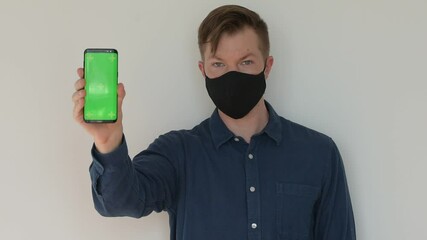 Poster - Portrait of man showing phone with chroma key copy space