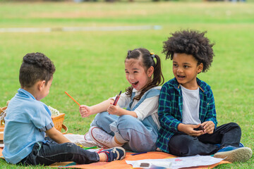 multi ethnic and diverse group of children playing together in park