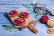 Three sandwiches with beetroot paste