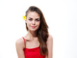 © SHOTPRIME STUDIO - attractive woman with flower in hair and in red t-shirt naked shoulders cropped view of model