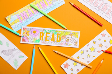 Wall Mural - Cute bookmarks with pencils on color background