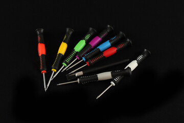 Canvas Print - Closeup of colorful screwdrivers on a black background