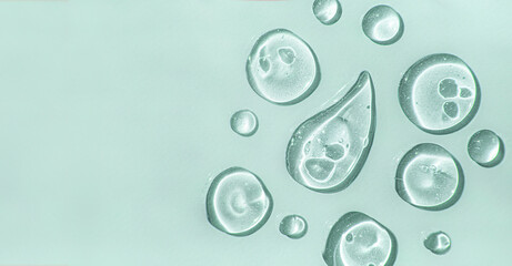 a aloe vera drops of liquid gel serum , texture micro bubble on green background, beauty concept, ho