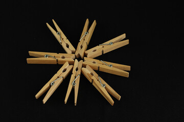 Wall Mural - Closeup of arranged wooden clips on a black background