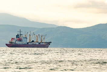 Wall Mural - fishing boat in gray morning on Pacific ocean off the coast of the Kamchatka Peninsula