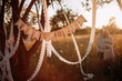 baby shower party in the park or garden. paper white garlands and the inscription baby shower. a decorated place for a baby shower party in a field or meadow illuminated by orange rays of the sun.
