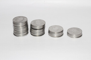 Wall Mural - Closeup shot of stacked coins isolated on a white background