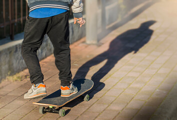 Wall Mural - legs on skateboard close up on the street