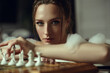 Close up portrait of a beautiful lady with updo hair sitting in the bath with foam and playing chess