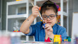 © Bangkok Click Studio - Asian girl with Down syndrome showing paint