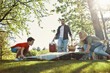 © gstockstudio - Happy young mother and father with little boy smiling while having picnic outdoors