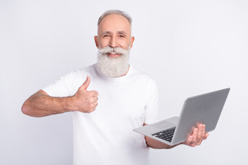 Sticker - Photo of positive happy charming old man hold computer laptop show thumb-up isolated on grey color background