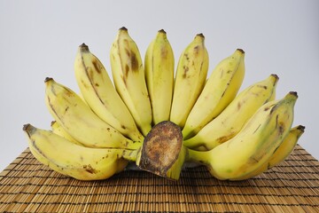 Yellow ripe banana, Namwa banana on wood background on white background.