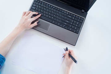 Poster - Women's hands and laptop. Place for text. Search for information on the Internet. Working on a computer.  Business woman working with a laptop. A woman using a laptop. Viewing the information.