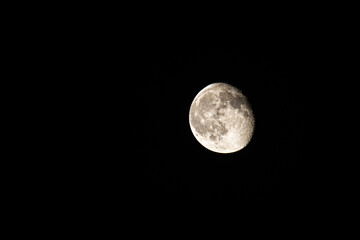 Wall Mural - waning gibbous moon on a black background