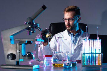 Poster - virologist works in a laboratory. laboratory technician is working on a vaccine. lots of tubes next 