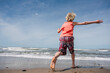 © Image Source RF - USA, California, Ventura, Rear view of boy running on beach