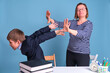 A woman holds a boy in a school uniform in handcuffs, arrest on a blue background. Problems with the law in the junior schoolboy at school education.