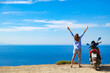 © astrosystem - Woman with scooter looking at the distant sea horizon.