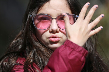 Wall Mural - young girl with pink sun glasses