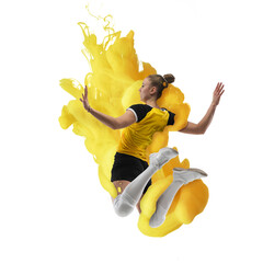 Wall Mural - Young girl volleyball player in explosion of yellow colored neon luiquid fluid isolated on white background.
