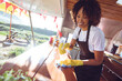© Wavebreak Media - Smiling mixed race woman cleaning counter in food truck