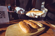 © Wavebreak Media - Midsection of mixed race woman preparing hot dogs behind counter in food truck
