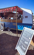 © Wavebreak Media - General view of food truck with red bunting and menu board against blue sky