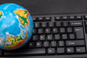 Globe on computer keyboard. Global computer business concept. Online travel